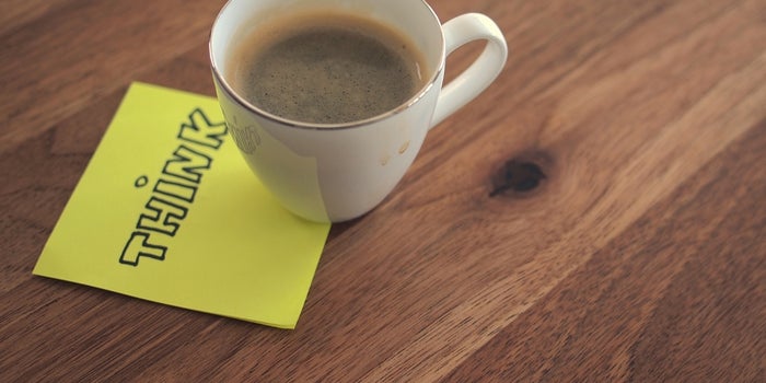 20150421132541-think-small-win-customer-loyalty-post-it-note-coffee-cup-mug-wood-desk-office-business